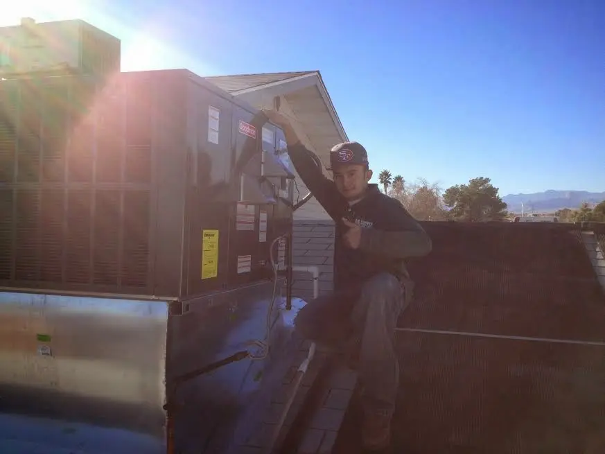 HVAC technician performing Air Duct Repair on a rooftop unit in Casa de Oro-Mount Helix